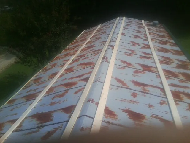 Rusted metal roof panels with new wood purlins before replacement — Storm Damage Roof Repair in Bantam by Roofing Brothers